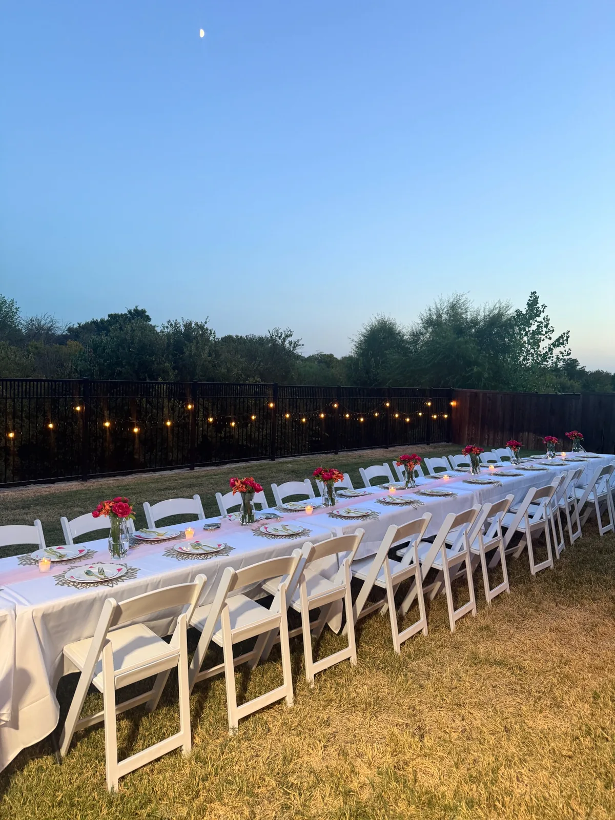 Wide view of Sweet Sixteen tablescape and string lights